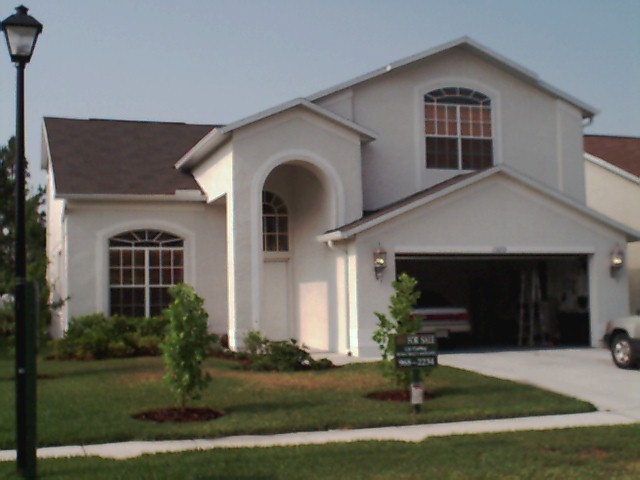 The front of the house
which shows proximity of neighbors and a couple of the trees I planted.