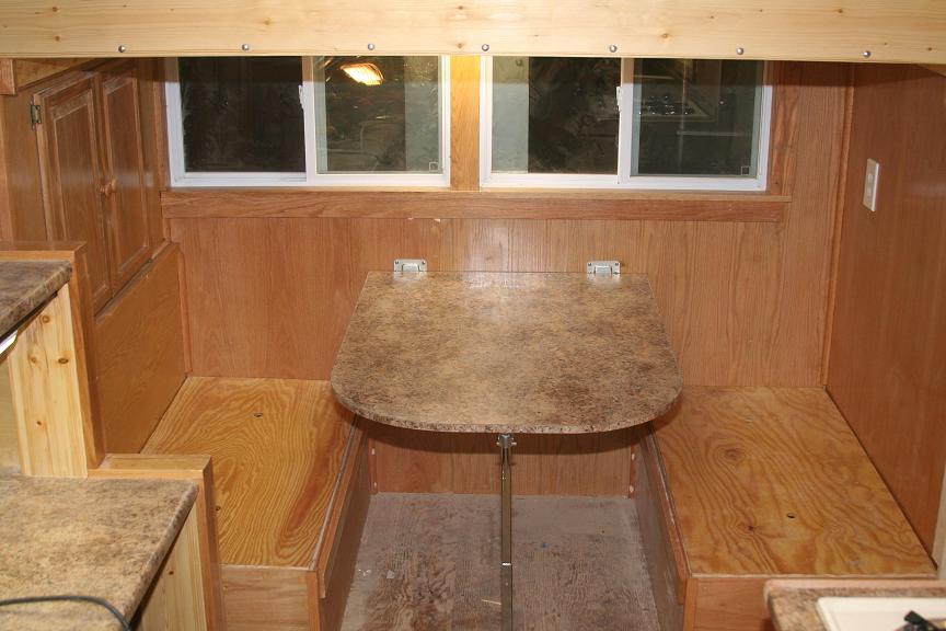 This is the dining area with fold down table that creates a bunk.