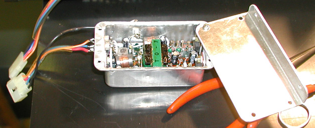 Fig. 4. Interior view of IC-2KL DC-DC converter, showing feedthrough capacitors. Click for larger image. Photo courtesy Frank A. Ellis, W3UHF.