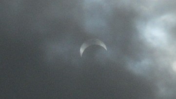 Eclipse Through Clouds