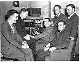 Chicago hamstation at the Hallicrafters office building. Bill Snyder at controls. Bob Leo man first in back of Snyder on left. This station was worked each day at noon Chicago time.