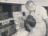 CMDR. GATTI and one of his radio operators check the expedition's itinerary as work on the Masai and Sonyo tribes was being finished. Having worked the entire array of its five stations, the radio section completed more than 4,000 contacts with all states in the U. S. and with every country in the world (except Tibet, where signals went unanswered). "Hams" everywhere eagerly requested confirmation cards.