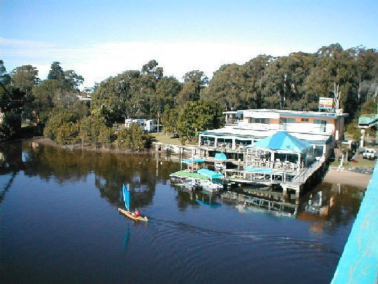 Ray Golden VK2BRG sailing a kayak in front of Anchors wharf restaurant, site of old DO MEE where the Urunga Radio Convention started.
