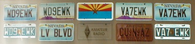 Photo - image of WD9EWK and VA7EWK license plates, surrounding a plate with the Arizona flag and other souvenir plates, on the wall above my radio gear at home