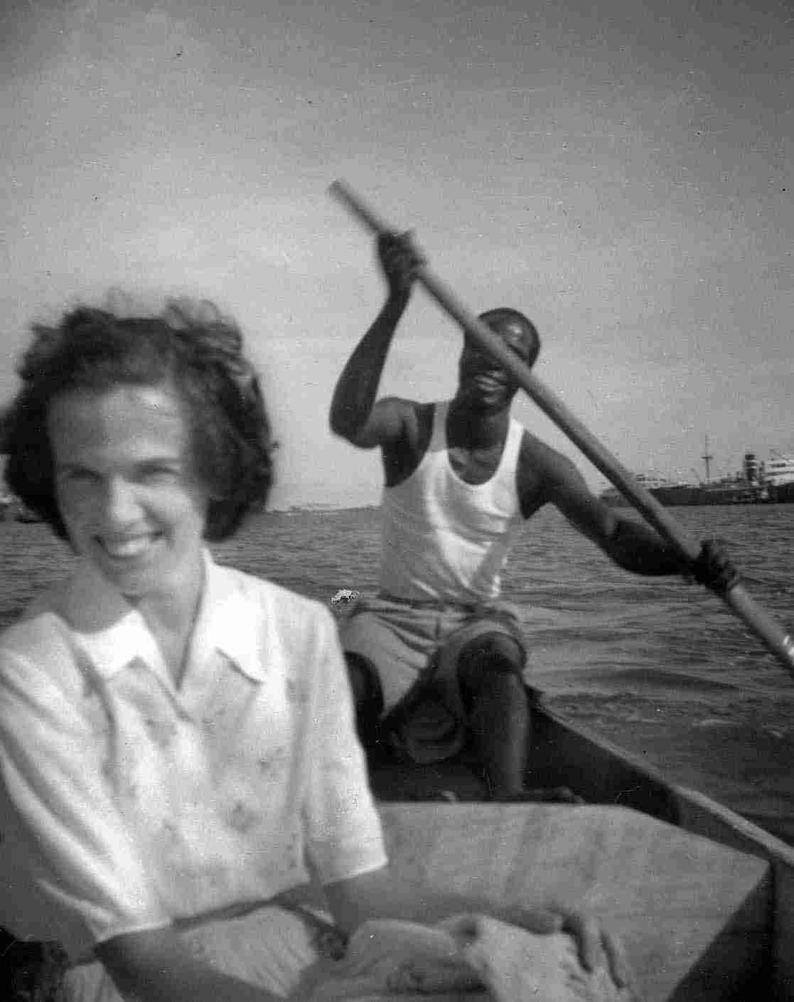 Olive in Lagos, Nigeria being paddled ashore by ship's boatman 'Tiger'.