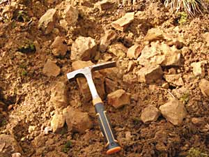 Area of a spoil heap which has been excavated to show the sand and rocks