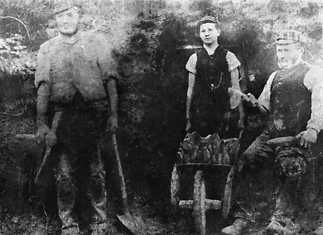 Three whetstone miners outside their mine
