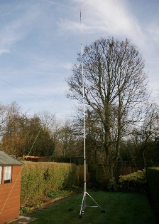 My prototype antenna erected in a small garden. The height to the top of the loading coil is around 30ft