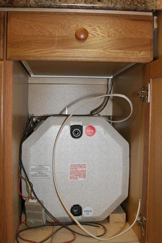 The hot water heater tucks nicely into this cabinet.