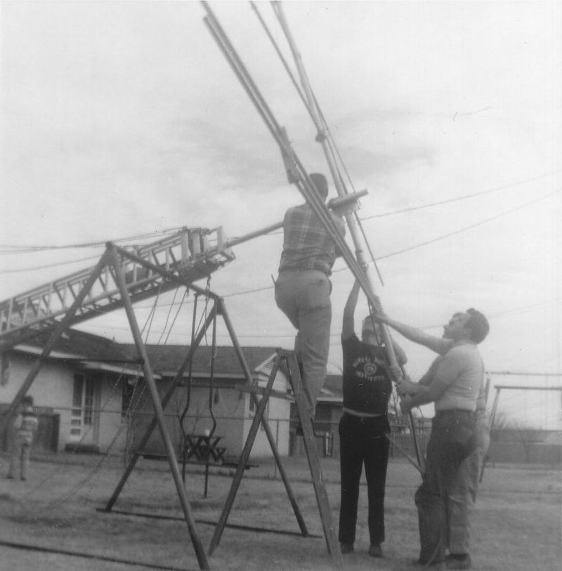 Picture of tower propped on neighbor's swingset.