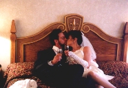 Roy and Paula kissing in bed just after a toast