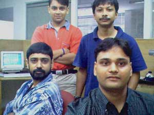 Ajay Bharadwaj (Video Production-Sitting Left), Kunal Gupta(Web Programmer-Standing Left), Sandeep Baruah(!-Standing Right), Gaurav Jain(Web Designer, Sitting Right)
