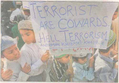 Muslim boys hold a placard during a protest in Siliguri against the terrorist attacks in Mumbai. Tribute to all those who lost their lives for our great nation.