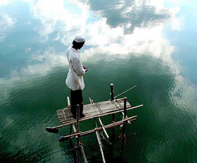 A pious muslim praying above the water