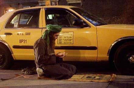Taxi driver praying (Namaaz) in the parking area.