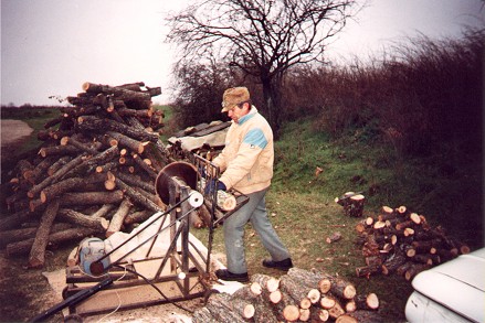 Cutting wood with his homemade saw