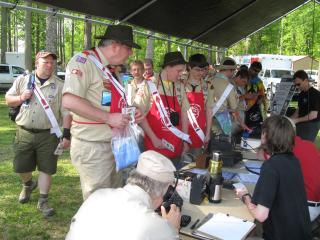 Scouts checking out the radio setup. Sitting at table from left, John, K4KBB, David, W4DWA, and Dave, KV4CN.