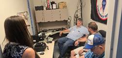A group of people sitting in a room

Description automatically generated