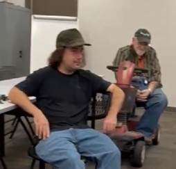 A group of men sitting on chairs

AI-generated content may be incorrect.