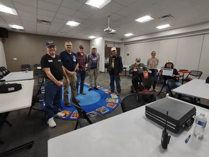 A group of people sitting in chairs

Description automatically generated