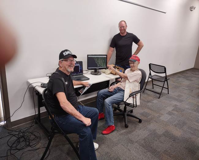 A group of people sitting in chairs in a room

Description automatically generated