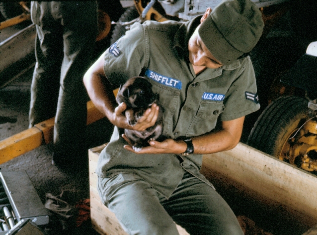 A1C Shifflet holding a puppy.